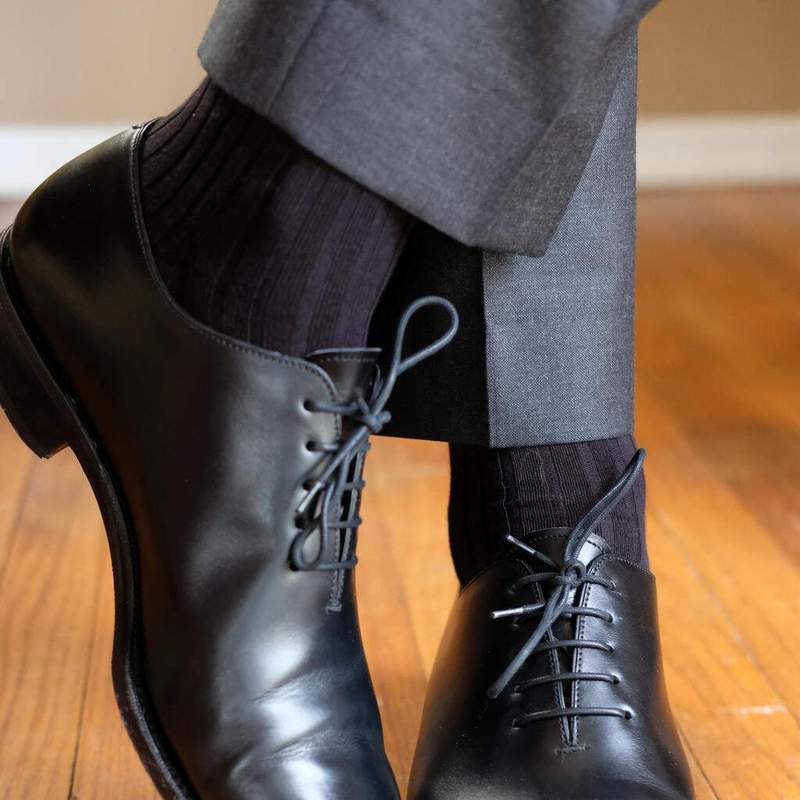 Серые брюки с чёрными носками и ботинками